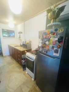 a kitchen with a refrigerator and a stove at Peace and love house in Santa Cruz
