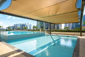 an outdoor swimming pool with a view of the city at Sky-High Central Dubai Gem: Burj Khalifa & Fountain View in Dubai