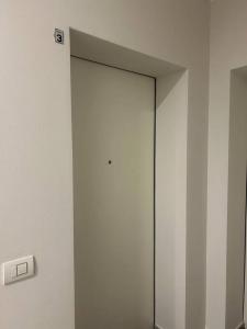 a white wall with a door in a room at Casa Ferrari in Montale +33 photos