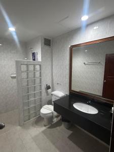 a bathroom with a toilet and a sink and a mirror at Lalisa Hotel Aonang in Ao Nang Beach