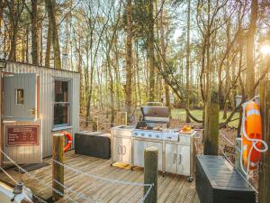 a outdoor kitchen with a stove on a deck at Chere Amie-qu7616 in Melton Constable