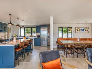 a kitchen and dining room with a table and chairs at Blue Seas in Mawgan Porth