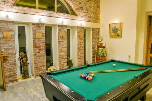 a pool table in a living room with a pool table at Villa "Forest way" in Pirdop