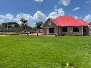 a house with a red roof on a yard at Same Harmony Hideaway in Zame
