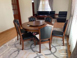 a dining room with a wooden table and chairs at Same Harmony Hideaway in Zame