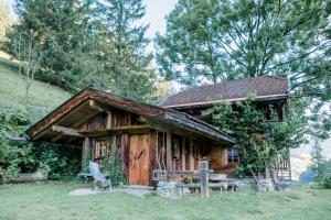 a log cabin with a bench in front of it at Bretei Hütte in Grossarl