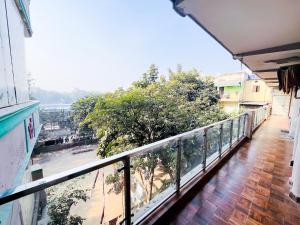 a balcony with a view of a river at Deluxe Room In Sarai Kaley Khan in New Delhi