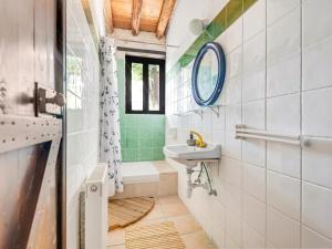 a bathroom with a sink and a toilet and a mirror at Cornaro House in Arsos