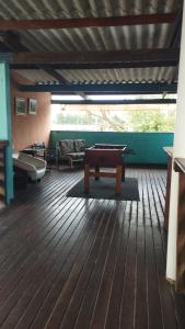 a room with a pool table on a wooden floor at Equilibra Soul in Caraguatatuba