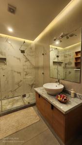 a bathroom with a sink and a shower at SURF PALACE BEACHFRONT APARTMENT Essaouira in Essaouira +27 photos