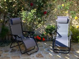 due sedie sedute accanto a un muro con fiori di Alojamientos El Horno a Montejo de la Sierra