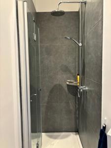 a shower with a glass door in a bathroom at Lovely small apartment in 'De Pijp' in Amsterdam