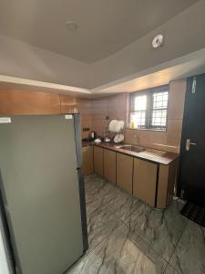 a large kitchen with a sink and a counter at MATHER RAJAGIRI FURNISHED APARTMENTS in Alwaye