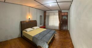 Postel nebo postele na pokoji v ubytování Bungalow Karo Hill
