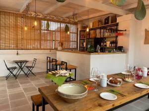 a kitchen and dining room with a wooden table at Tenuta Amostuni-Country House in Ostuni