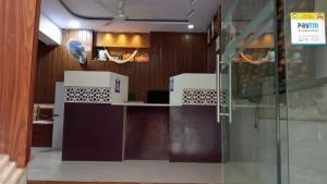 a restaurant with a counter and a glass door at Terminus Square in Kurla