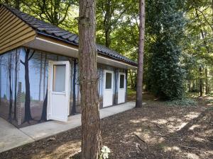 a small house with white doors in the woods at Jacobs Folly-qu7115 in Melton Constable