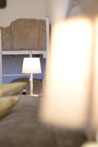 a bedroom with a bunk bed and a lamp at The Rooms of Swami in Bari