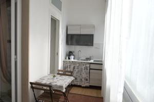 uma cozinha com uma mesa e uma cadeira num quarto em The Rooms of Swami em Bari