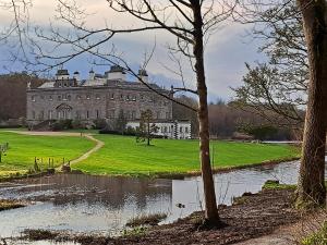 a large house with a pond in front of it at 203 Harbour Mill in Westport