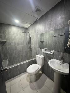 a bathroom with a toilet and a sink at Kay Hotel and Residences in Angeles