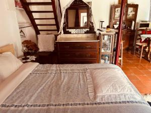 a bedroom with a bed and a dresser with a mirror at Mãe Home Carril in Caldas da Rainha