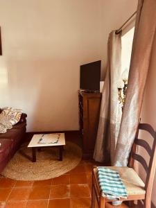 a living room with a couch and a tv at Mãe Home Carril in Caldas da Rainha