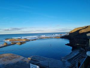 a large pool of water next to the ocean at Rockpool - Bude in Bude