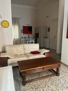 a living room with a white couch and a coffee table at Salento b&b Trepuzzi in Trepuzzi