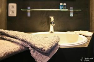 a bathroom with a sink and a towel at Les Braises de la Semois in Florenville +14 photos