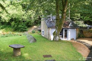 a stone house with a bench in front of it at Les Braises de la Semois in Florenville