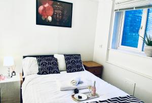 a bedroom with a bed with a tray of food on it at Progress Living in Gaywood