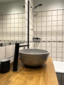 a bathroom with a large stone tub on a wooden counter at Apartamento dúplex en el puente histórico, Gra de Fajol in Camprodon +21 photos