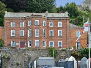 a large brick building with a flag in front of it at Nelson - Fdg in Ilfracombe