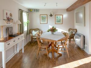 a dining room with a table and chairs at The Old Stable - Dey in Marshwood