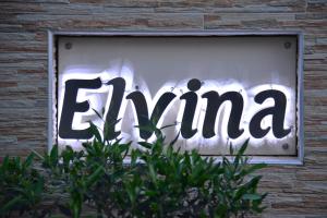 a sign that says emima is displayed in a window at Εlvina apartments in Leptokaria