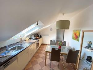 a kitchen with a sink and a table with chairs at Ferien am Königshof in Georgsmarienhütte +15 photos