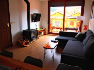 a living room with a couch and a wood stove at Alojamiento Rural Los Hacheros in Tragacete