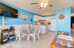 a kitchen and dining room with a table and chairs at 0305 Mako Your Dreams Come True by Atlantic Towers in Carolina Beach +14 photos