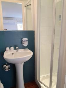 a bathroom with a sink and a shower at Fasthotel Narbonne in Narbonne