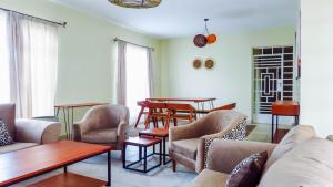a living room with a couch and chairs and tables at Swara Ranch Nanyuki in Nanyuki