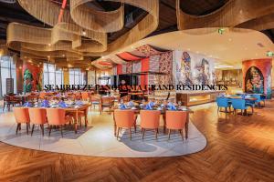 a restaurant with tables and chairs in a room at SeaBreeze Panorama Grand Residences in Nha Trang