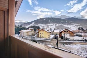 a view from a window of a town in the mountains at Chalet Meridiana in Bormio