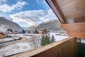 a room with a view of a snowy mountain at Chalet Meridiana in Bormio