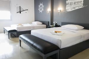 Postel nebo postele na pokoji v ubytování GC Suites