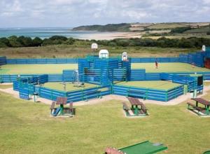 una vista aérea de una pista de tenis con mesas y bancos en 31 Beachlands en Cowes