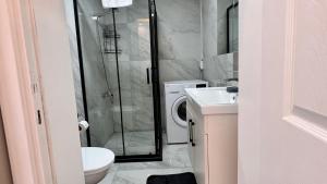 a bathroom with a shower and a toilet and a sink at Kule Apart in Istanbul