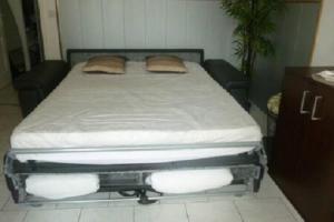 a bed with two pillows on it in a room at Villa SYMPHONY A PIANA CORSE DU SUD in Piana