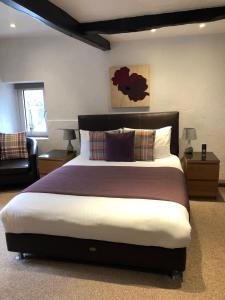 a bedroom with a large bed and a couch at Ramblers Rest in Castleton
