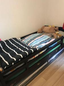 a bed with a stuffed animal on top of it at 3 chambres/ bail mobilité possible in Vitry-sur-Seine